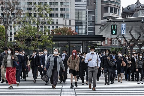 Travelers and commuters walk outside Tokyo station in the center of the Japanese capital. The country's inflation has hit its highest level in four decades due largely to rising energy costs and a weak yen. (Photo by RICHARD A. BROOKS / AFP)