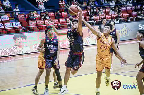 Louie Sangalang of Letran College beats Toby Agustin of Mapua University for the rebound in their Season 98 NCAA basketball game yesterday. The Knights won, 74-58. | PHOTOGRAPH COURTESY OF NCAA