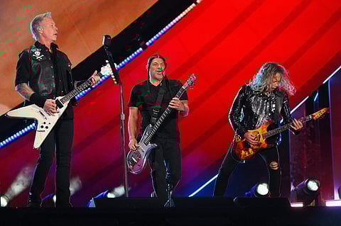 James Hetfield (left), Robert Trujillo (center), and Kirk Hammett (right) of Metallica perform during the Global Citizen Festival at Central Park in New York on 24 September 2022. (Photo by ANGELA WEISS / AFP)
