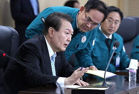 This handout photo taken and released on 2 November 2022 by the South Korean Presidential Office via Yonhap news agency shows South Korean President Yoon Suk-yeol (left) speaking at a meeting of the National Security Council over North Korea's missile launch, at the presidential office in Seoul. (Photo: Handout / South Korean Presidential Office / AFP)
