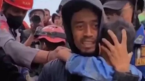 Quake rescuers pull boy, 6, from rubble