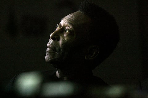 Brazilian soccer legend Edson Arantes do Nacimento, known as Pele, looks on as he attends the opening ceremony of the "Marks of the King" exhibition in Brasilia. - The 82-year-old icon was hospitalized in Sao Paulo on November 29, 2022, for what doctors said was a "reevaluation" of the chemotherapy he has been undergoing since surgery to remove a colon tumor in September 2021. Photo by JOEDSON ALVES / AFP