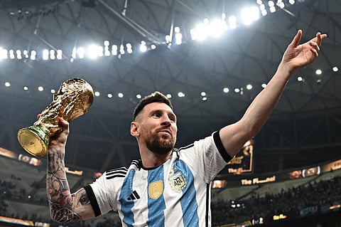 LIONEL Messi displays the trophy after leading Argentina to a dramatic penalty shootout victory over France in the final of the World Cup. Photo by Anne-Christine POUJOULAT / AFP