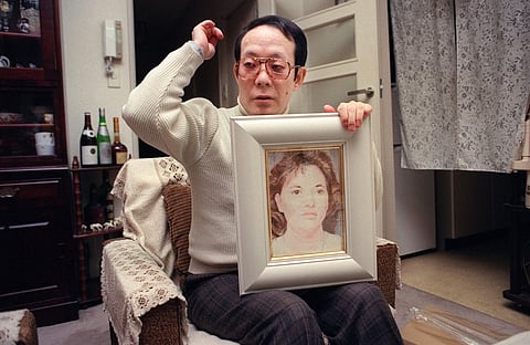 Issei Sagawa, murderer of Dutch student Renée Hartevelt, holding one of his pictures featuring a Western woman, meets with an AFP journalist on February 05, 1992, in his bachelor's apartment in Yokohama. Photo by JUNJI KUROKAWA / AFP