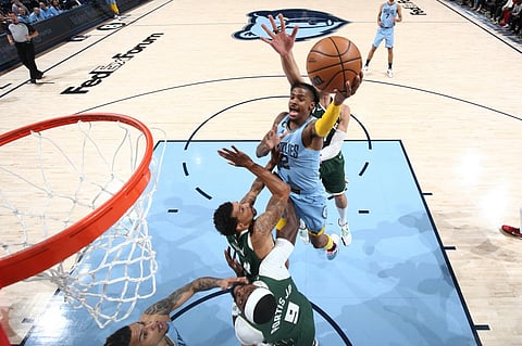 Ja Morant of the Memphis Grizzlies drives to the basket during the game against the Milwaukee Bucks. Photo by JOE MURPHY / NBAE / Getty Images / Getty Images via AFP