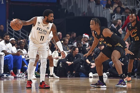 Kyrie Irving #11 of the Brooklyn Nets looks to pass the ball during the game against the Cleveland Cavaliers on December 26, 2022 at Rocket Mortgage FieldHouse in Cleveland, Ohio. Photo by David Liam Kyle / NBAE / Getty Images / Getty Images via AFP