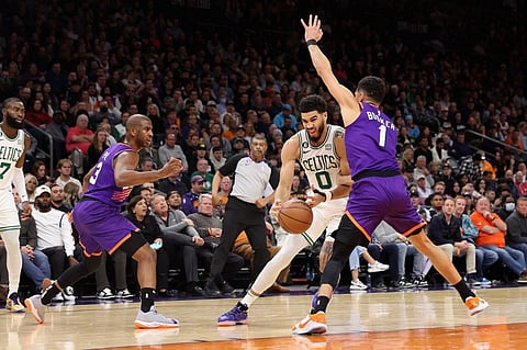 Jayson Tatum of the Boston Celtics drives the ball against Devin Booker of the Phoenix Suns during the first half of the NBA game at Footprint Center. Photo by Christian Petersen / GETTY IMAGES NORTH AMERICA / Getty Images via AFP