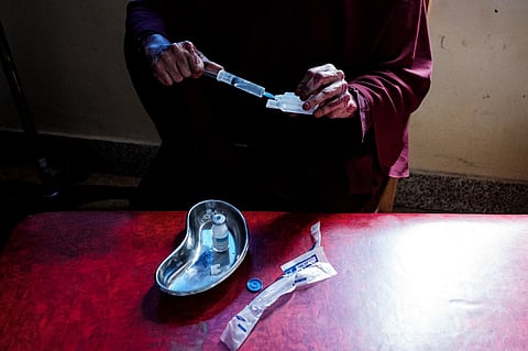 A nurse prepares antibiotics in a ward treating malnourished children at The Banadir Maternity and Children Hospital in Mogadishu, Somalia. (Photo by GUY PETERSON / AFP)