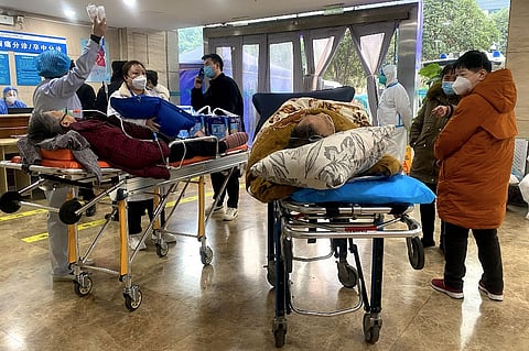 Covid-19 patients on stretchers in the emergency ward of the First Affiliated Hospital of Chongqing Medical University in China's southwestern city of Chongqing on 22 December 2022. (Photo by NOEL CELIS / AFP)