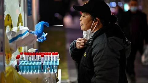 China's economy has been hammered by years of strict Covid containment measures, including lockdowns and mass testing (Photo by HECTOR RETAMAL / AFP)