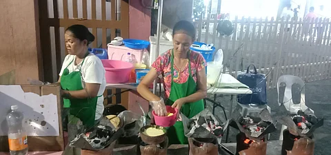 SITUATED in front of the San Sebastian Parish in Barangay Pinagbuhatan, Eduardo’s Bibingka offers kakanin that are popular during the Christmas season. Above, two cooks start preparing the native delicacies. | Photograph by Neil Alcober for the Daily Tribune