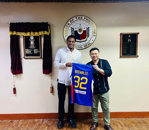 Justin Brownlee hands his Gilas Pilipinas jersey to Sen. Sonny Angara following Senate’s approval of his application for naturalization. Photo courtesy of Sen. Sonny Angara