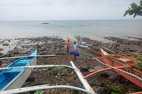 “The eight fishermen on board encountered strong winds and big waves during a fishing venture at the vicinity waters off San Ricardo, Southern Leyte. They tried to take shelter, but their motor banca submerged due to the prevailing sea and weather conditions,” the Philippine Coast Guard report said. (Photo courtesy of Philippine Coast Guard)