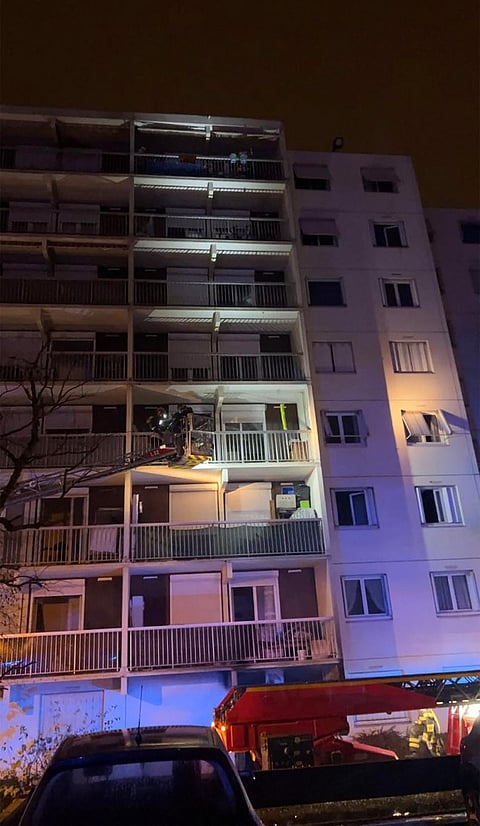 This handout picture released by ASSED shows firefighters at work in a building of the Mas-Du-Taureau neighborhood where a fire caused many victims, including children, in Vaulx-en-Velin, east of Lyon, southeastern France, on 16 December 2022. (Photo by ASSED / ASSED / AFP)