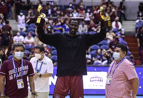 Photograph by Rio Deluvio for the Daily Tribune @tribunephl_rio
MALICK Diouf of University of the Philippines lifts his trophies after emerging as Most Valuable Player and Mythical Team member of Season 85 UAAP men’s basketball tournament.