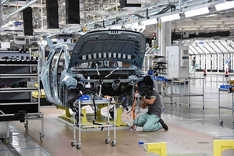 PHOTOGRAPH COURTESY OF CHINA DAILY
WORKER meticulously assembles the car’s engine.