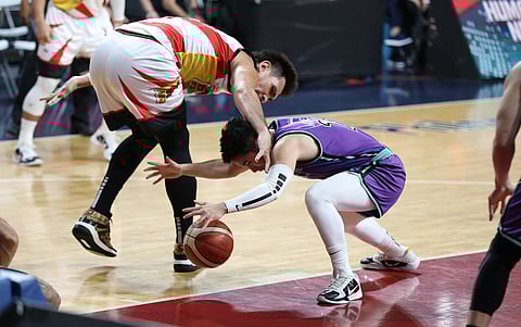 June Mar Fajardo of San Miguel and Aljun Melecio of Converge engage in a battle for possession during their PBA Commissioner’s Cup quarterfinal game yesterday. The Beermen won, 114-96. Photo courtesy of PBA
