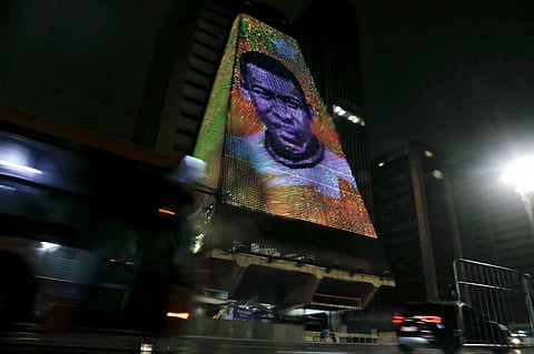 An image of Brazilian football legend Pele, whose death was announced earlier in the day, is displayed at the headquarters of the Federation of the Industries of the State of Sao Paulo in Sao Paulo, Brazil, on 29 December 2022. (Photo by MIGUEL SCHINCARIOL / AFP)