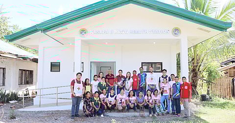 ICRC staff, local officials, and barangay health workers in front of the newly constructed health station in Kasapa II. | PHOTOGRAPHS COURTESY OF MELRICK LUCERO