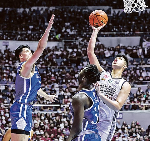 For all the marbles University of the Philippines’ Carl Tamayo (right) tries to score against Ateneo' defenders Ange Kouame (right) and Kai Ballungay during Game 3 of the UAAP Season 85 finals at the Smart Araneta Coliseum Monday. | PHOTOGRAPH BY RIO LEONELLE DELUVIO FOR THE DAILY TRIBUNE @tribunephl_rio