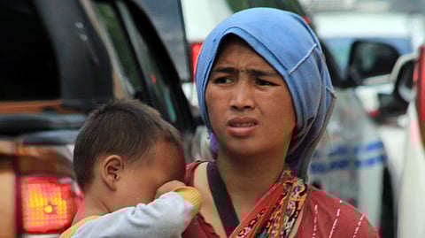 (FILE PHOTO) WITH a baby in tow, this Badjao woman begs for alms on roadsides unmindful of the risks.