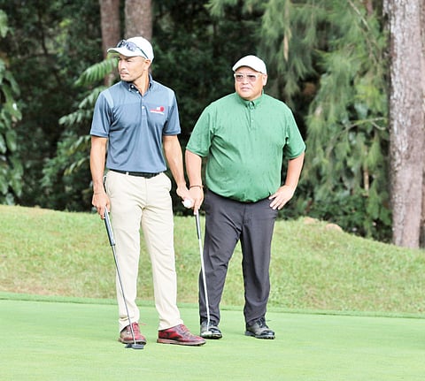 ACTOR Derek Ramsay (left) of Time Cargo Logistics Team 2 and Raymond Bunquin of Forest Hills Team 2 stand on the ninth green during the fourth day of the 72nd Fil-Am Invitational at the Camp John Hay in Baguio City on Friday. | Photograph by Joey Sanchez Mendoza for the daily tribune @tribunephl_al