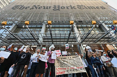 Benefits issue The iconic facade of the New York Times, the site of many a protest rally including this one against extremism, is expected to go quiet for at least a day as its workers go on strike. | AGENCE FRANCE-PRESSE