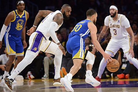 LeBron James of the Los Angeles Lakers defends Stephen Curry of the Golden State Warriors during the game during the Western Conference Semi Finals during the 2023 NBA Playoffs on May 6, 2023 at Crypto.Com Arena in Los Angeles, California. Photo by Noah Graham / NBAE / Getty Images / Getty Images via AFP
