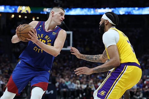 Nikola Jokic #15 of the Denver Nuggets looks to pass the ball against Anthony Davis #3 of the Los Angeles Lakers during the third quarter in game one of the Western Conference Finals at Ball Arena on 16 May. Photo by MATTHEW STOCKMAN / GETTY IMAGES NORTH AMERICA / Getty Images via AFP