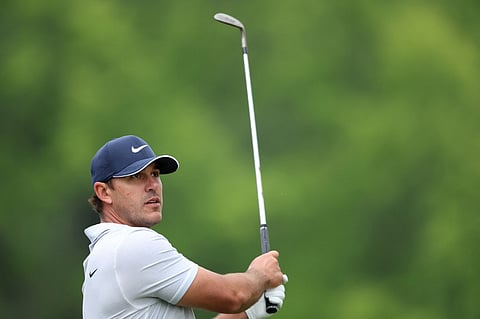 Brooks Koepka of the United States watches his shot during the third round of the 2023 PGA Championship at Oak Hill Country Club on 20 May 2023 in Rochester, New York)