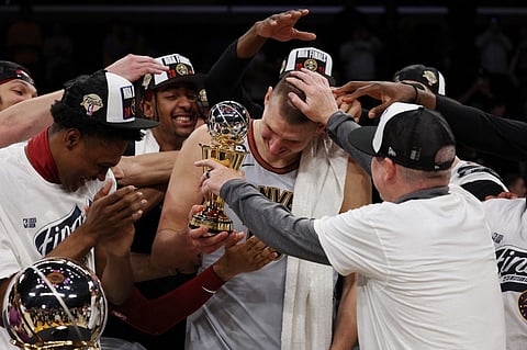 Nikola Jokic #15 of the Denver Nuggets celebrates with teammates after receiving the Most Valuable Player Trophy following game four of the Western Conference Finals against the Los Angeles Lakers at Crypto.com Arena on 22 May in Los Angeles, California. Photo by Harry How / GETTY IMAGES NORTH AMERICA / Getty Images via AFP