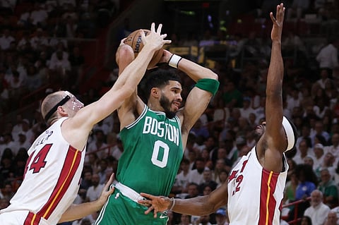 Jayson Tatum #0 of the Boston Celtics is guarded by Cody Zeller #44 and Jimmy Butler #22 of the Miami Heat during the first quarter in game four of the Eastern Conference Finals at Kaseya Center on 23 May in Miami, Florida. Photo by Megan Briggs / GETTY IMAGES NORTH AMERICA / Getty Images via AFP