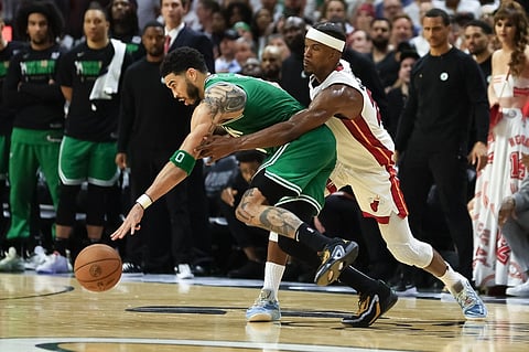 Jayson Tatum #0 of the Boston Celtics controls the ball against Jimmy Butler #22 of the Miami Heat during the fourth quarter in game six of the Eastern Conference Finals at Kaseya Center on May 27, 2023. Photo by Mike Ehrmann / GETTY IMAGES NORTH AMERICA / Getty Images via AFP