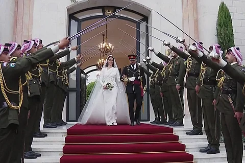 This screen grab taken from a footage released by the Jordanian Royal Palace shows Crown Prince Hussein and his wife Saudi Rajwa al-Seif leaving the Zahran Palace in Amman following their wedding ceremony on 1 June 2023. The ceremony was held in the mid-century Zahran Palace -- the site of other key royal weddings including that of King Abdullah II to Queen Rania as well as that of his father, the late King Hussein bin Talal. (Photo by Jordanian Royal Palace / AFP)