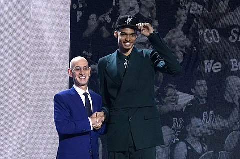 French basketball player Victor Wembanyama (R) shakes hands with NBA commissioner Adam Silver after being picked by the San Antonio Spurs during the NBA Draft at Barclays Center in New York city, on June 22, 2023. France's Victor Wembanyama was chosen with the top pick in the NBA Draft by the San Antonio Spurs on June 22, 2023, sparking wild celebrations as the Texas club reveled in landing the gifted teenager seen as a once-in-a-generation talent. Photo by TIMOTHY A. CLARY / AFP