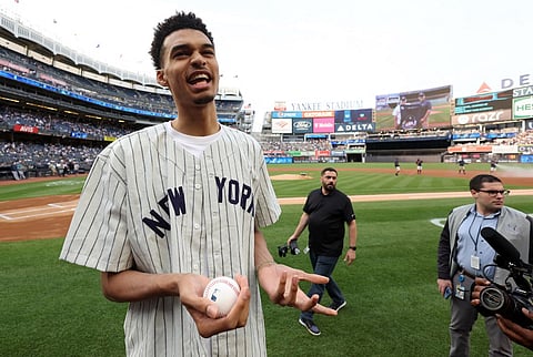 Victor Wembanyama, projected first round pick in the 2023 NBA draft, prepares to throw out the ceremonial first pitch prior to the game between the Seattle Mariners and the New York Yankees at Yankee Stadium on June 17, 2023 in New York City. Photo by JAMIE SQUIRE / GETTY IMAGES NORTH AMERICA / Getty Images via AFP