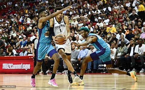 San Antonio Spurs' Victor Wembanyama controls the ball during the NBA Summer League game between the San Antonio Spurs and Charlotte Hornets, at the Thomas and Mack Center in Las Vegas, Nevada, on July 7, 2023. Photo by Patrick T. Fallon / AFP