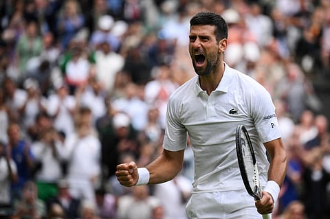 Serbia's Novak Djokovic celebrates winning against Russia's Andrey Rublev during their men's singles quarter-finals tennis match on the ninth day of the 2023 Wimbledon Championships at The All England Tennis Club in Wimbledon, southwest London, on July 11, 2023. (Photo by Daniel LEAL / AFP) / RESTRICTED TO EDITORIAL USE