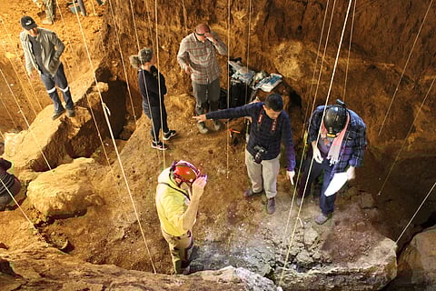 Filipino geoarchaeologist Vito Hernandez (2nd from right, with camera) with his fellow researchers in Tam Pà Ling in northern Laos. (Photo by Kira Westaway / Macquarie University via UP Diliman College of Science / Facebook)