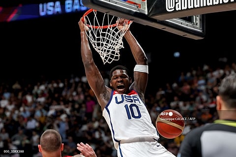 USA's Anthony Edwards dunks the ball during the Basketball Showcase friendly match between the USA and Germany at the Etihad Arena in Abu Dhabi on August 20, 2023. (Photo by Giuseppe CACACE / AFP)