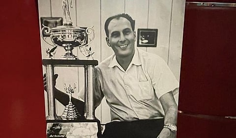 Caloy Loyzaga showing one of the many trophies he won in an illustrious basketball career.