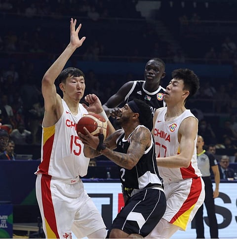 Carlik Jones of South Sudan attacks the defense of Zhou Qi and Zhang Zhenlin of China during their FIBA Basketball World Cup game. | Photograph by JOEY SANCHEZ MENDOZA for the Daily Tribune @tribunephl_joey