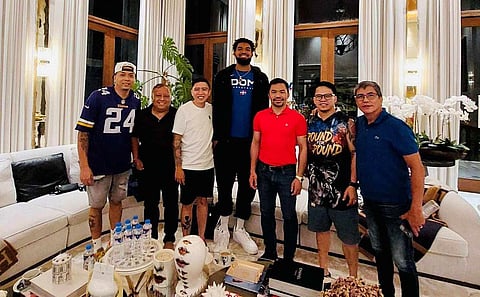 Manny Pacquiao and Karl-Anthony Towns of the Dominican Republic exchange pleasantries during a visit by the National Basketball Association player at the boxing legend’s Forbes Park residence late Saturday. (Winchell Campos)