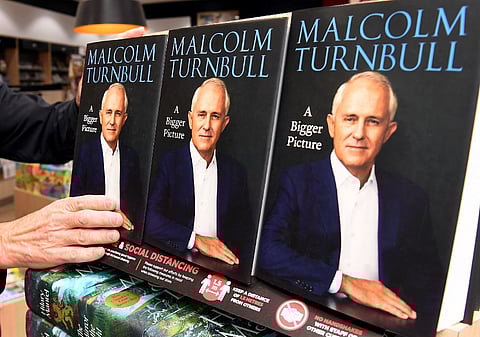 FILE PHOTO: Copies of former Australian prime minister Malcolm Turnbull autobiography are placed on the shelf after it's Australian release in Melbourne on 20 April 2020. (Photo by William WEST / AFP)
