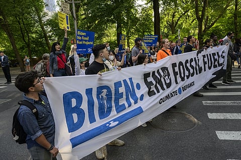 FILE PHOTO: Climate activists demonstrate to end all fossil fuels in Central Park in New York. (Photo by ANGELA WEISS / AFP)