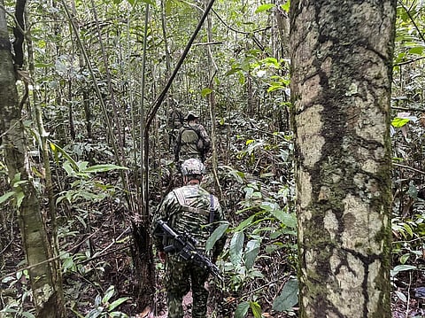 FILE PHOTO: This handout picture released by the Colombian Army shows soldiers searching for the missing chidren at the Colombian Amazon forest in the municipality of Solano, department of Caqueta, Colombia on 23 May 2023. (Photo by Handout / Colombian Army / AFP)
