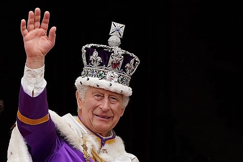 FILE PHOTO: Britain's King Charles III, wearing the Imperial state Crown, waves from the Buckingham Palace balcony. (Photo by Stefan Rousseau / POOL / AFP)