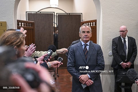Ian Lundin (C), former chairman of the Swedish oil company Lundin Oil, gives a statement to the press upon arrival on 5 September 2023 to the District Court in Stockholm, Sweden, prior to the start of his trial as he is charged for suspected complicity in war crimes in Sudan. (Photo by Jonathan NACKSTRAND / AFP)