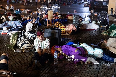 Residents take shelter ouside at a square following an earthquake in Marrakesh on 9 September 2023. Nearly 300 people were killed after a powerful earthquake rattled Morocco on 8 September night, according to a preliminary government count, with Marrakesh residents reporting "unbearable" screams followed the 6.8-magnitude quake. (Photo by Fadel SENNA / AFP)