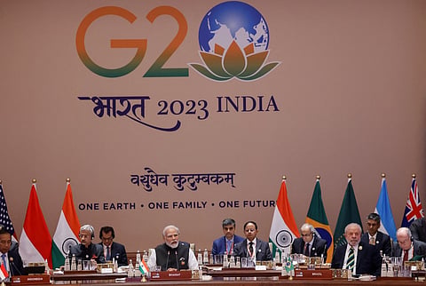 India's Prime Minister Narendra Modi (C) speaks during the first session of the G20 Leaders' Summit at the Bharat Mandapam in New Delhi on 9 September 2023. (Photo by Ludovic MARIN / POOL / AFP)